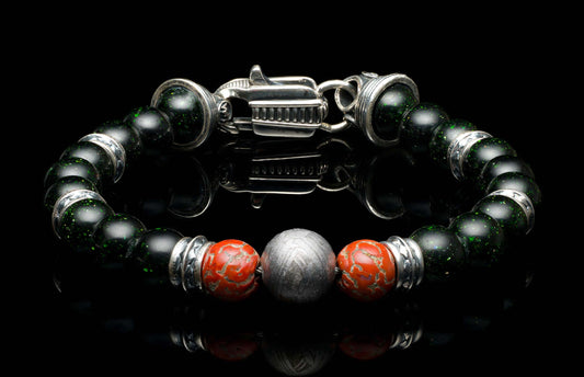 Handcrafted William Henry men's bracelet with dinosaur bone and shimmering green goldstone beads surround a singular Gibeon meteorite bead, accented with sculpted sterling silver and a custom clasp