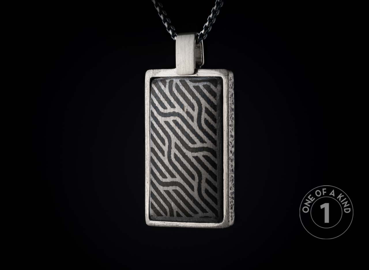 One of a kind sterling silver pendant necklace from William Henry with a laser engraved meteorite inlay.